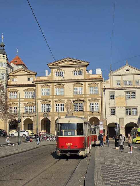 3 : img_1 - Red tram number 12 in a European city square representing the journey of entertainment