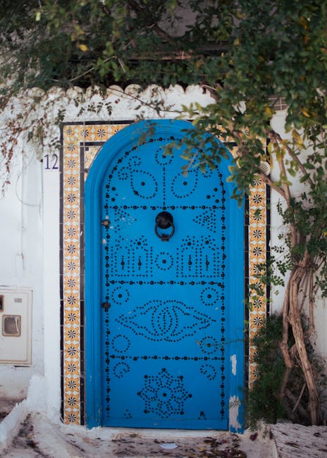 5 : img_3 - Ornate blue door with number 12 above representing exclusive access services
